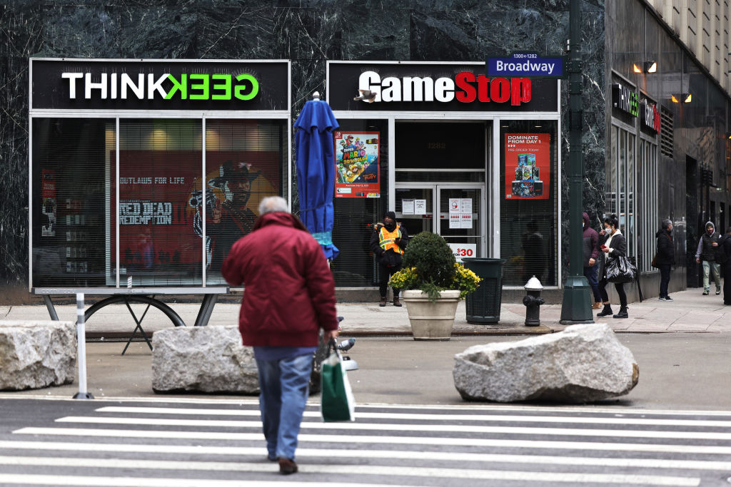 NEW YORK, NEW YORK - JANUARY 27: People walk past a GameStop store in Midtown Manhattan on January 27, 2021 in New York City. Stock shares of videogame retailer GameStop Corp has increased 700% in the past two weeks due to amateur investors. (Photo by Michael M. Santiago/Getty Images)