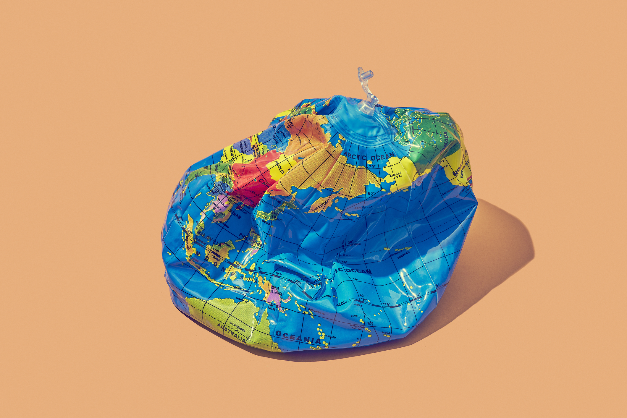 Deflated earth placed on a colored background