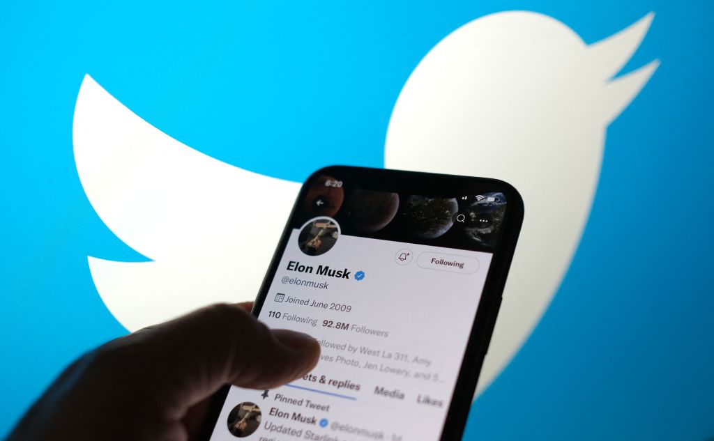 This illustration photo taken May 13, 2022, displays Elon Musks Twitter account with a Twitter logo in the background in Los Angeles. - Elon Musk sent mixed messages Friday about his proposed Twitter acquisition, pressuring shares of the microblogging platform amid skepticism on whether the deal will close.
In an early morning tweet, Musk said the $44 billion takeover was 