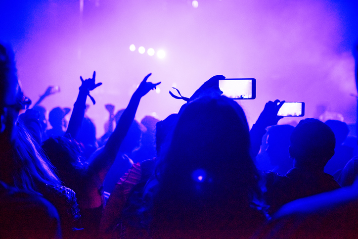 Silhouette of hands recording a concert with smart phones. Crowd of people using smart phones to photographing a concert