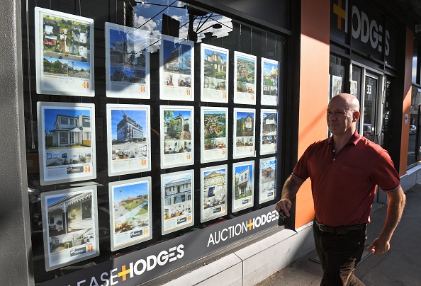 A man walks past a real estate agent's window advertising houses for sale and auction in Melbourne on May 1, 2019. - Australian property prices fell faster in the past year than at any time since the global financial crisis, a closely watched report said May 1, fuelling speculation of a pre-election interest rate cut. (Photo by William WEST / AFP)        (Photo credit should read WILLIAM WEST/AFP via Getty Images)