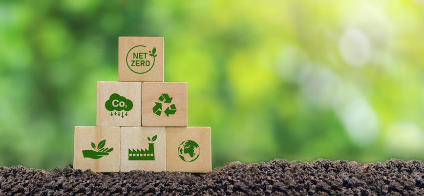 Carbon neutral and net zero concept natural environment Climate-neutral long-term strategy greenhouse gas emissions targets Wooden block with green net center icon and world save icon on green background.