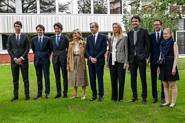 Chairman and Chief Executive of LVMH Bernard Arnault (C) poses for pictures with his wife Helene (C-L), and his children Antoine (3rd-R), Delphine (4th-R), Alexandre (L) and Frederic (2nd-L) during the inauguration of the Jean Arnault campus, named after his father, at the EDHEC business school in Roubaix on July 9, 2021. (Photo by DENIS CHARLET / AFP) (Photo by DENIS CHARLET/AFP via Getty Images)