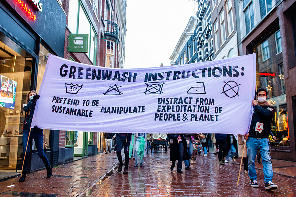 AMSTERDAM, NETHERLANDS - 2021/11/27: XR activists hold a banner against consumerism during the demonstration.
Extinction Rebellion organized in the center of Amsterdam a fashion parade, to mock fast fashion and to bring attention to the fast fashion industrys exploitative, profit-oriented, and greenwashing practices. The climate activists marched through the main shopping streets dancing and wearing repaired and second-hand clothes. (Photo by Ana Fernandez/SOPA Images/LightRocket via Getty Images)