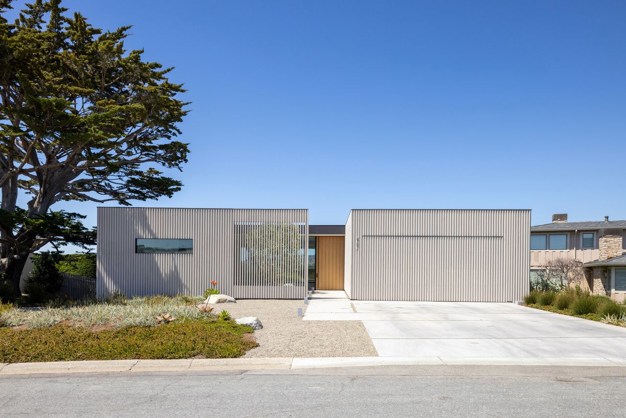 The new contemporary home in Carmel, Calif., is dubbed Mullet House because it gives a hint from the front that something interesting is happening on the other side.