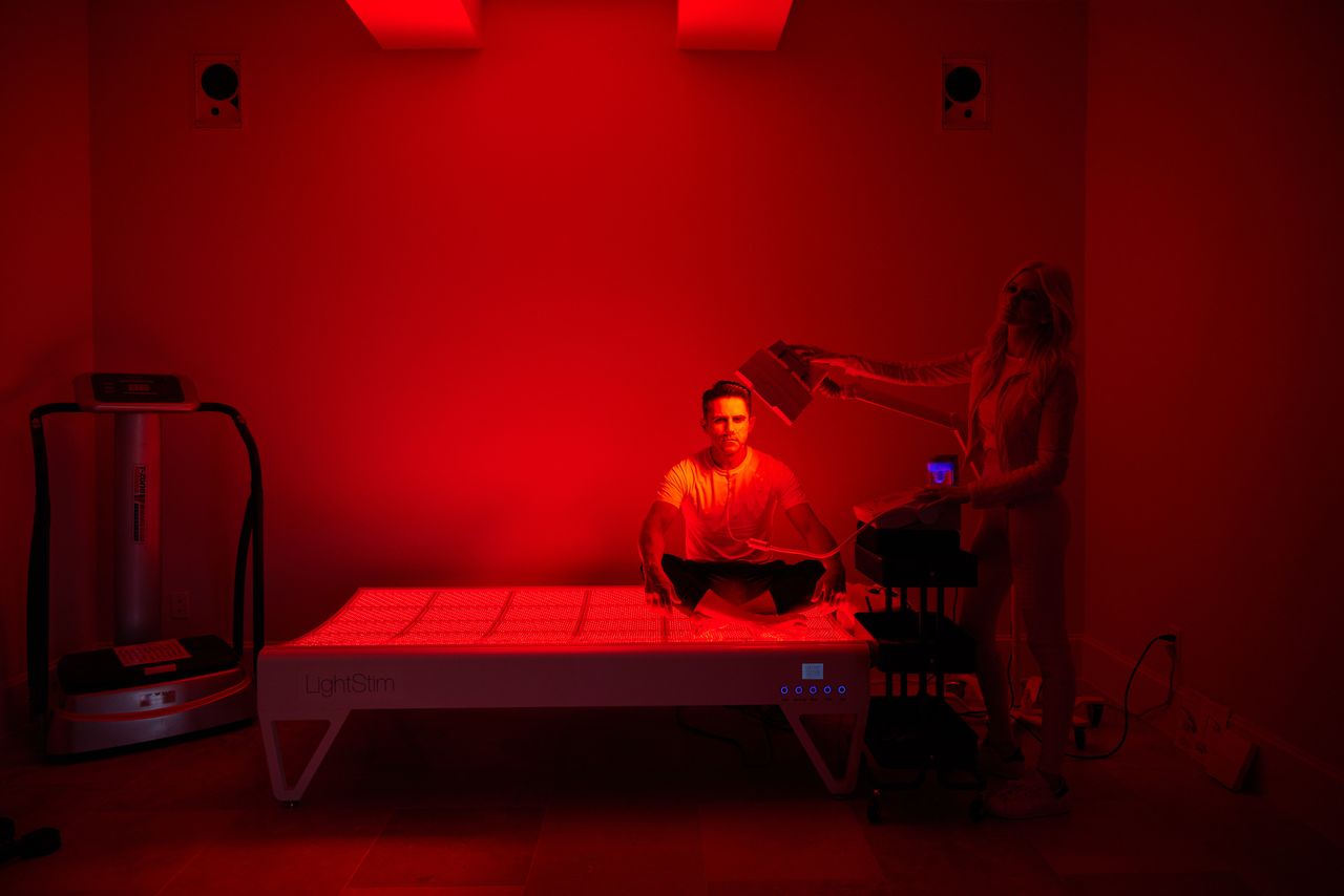 Ari and Kellie Rastegar use the light-therapy bed in their workout room. ‘Biohacking is a family practice for us,’ Ari Rastegar says. AMY MIKLER FOR THE WALL STREET JOURNAL