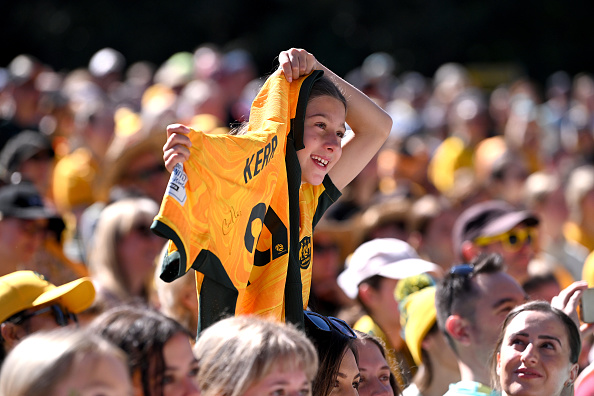 BRISBANE, AUSTRALIA - AUGUST 20: A young girl shows her support as she holds up a Matildas jersey with Sam Kerr's name on the back during the Australian Matildas community reception following their 2023 FIFA Women's World Cup campaign, at City Botanic Gardens on August 20, 2023 in Brisbane, Australia. (Photo by Bradley Kanaris/Getty Images)