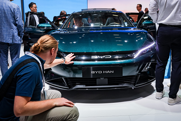 Visitors look at an BYD Han electric car of Chinese car brand BYD at the IAA Mobility 2023 international motor show on September 6, 2023 in Munich, Germany.  (Photo by Leonhard Simon/Getty Images)